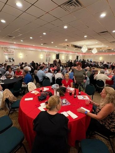 Large group at a banquet or conference in a hall.