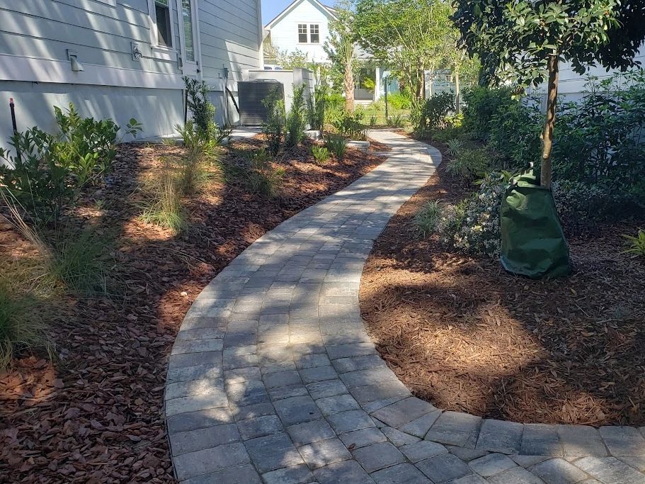 Charming garden pathway with stone pavers, winding through beautifully landscaped greenery