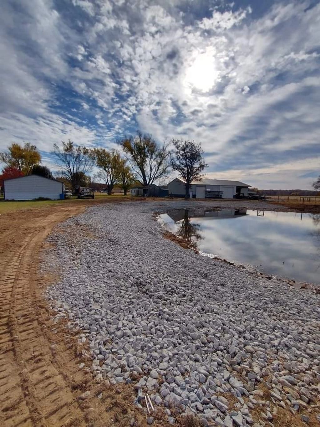 Pond all cleaned up with gravel around it.
