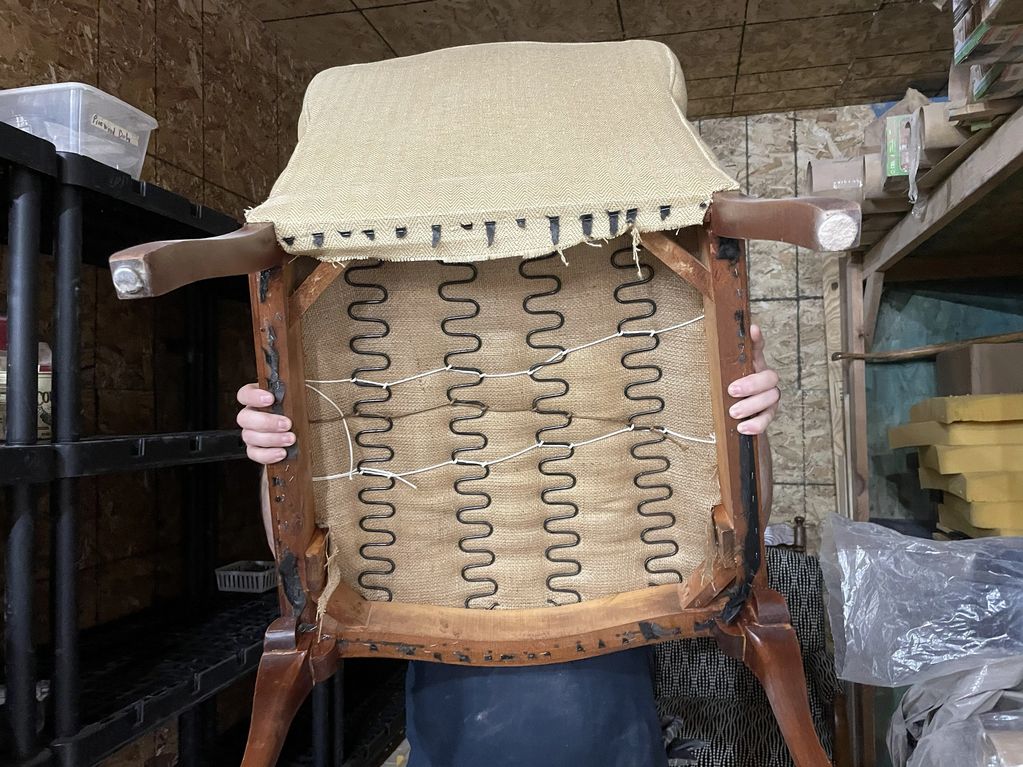 bottom side of chair exposing a spring structure