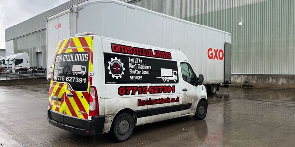 Picture of DMS Van with white lorry whose tail lift is being repaired.