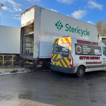 Picture of DMS Van with white lorry whose tail lift is being repaired.