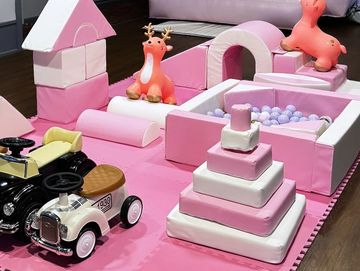 Pink and white toy playset with cars and animal figures.
