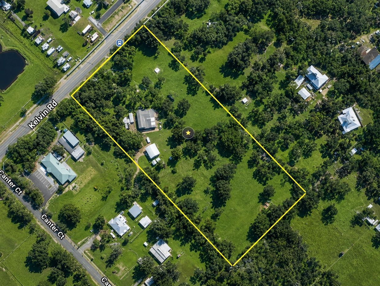 Aerial view of a green property outlined in yellow with buildings and trees.