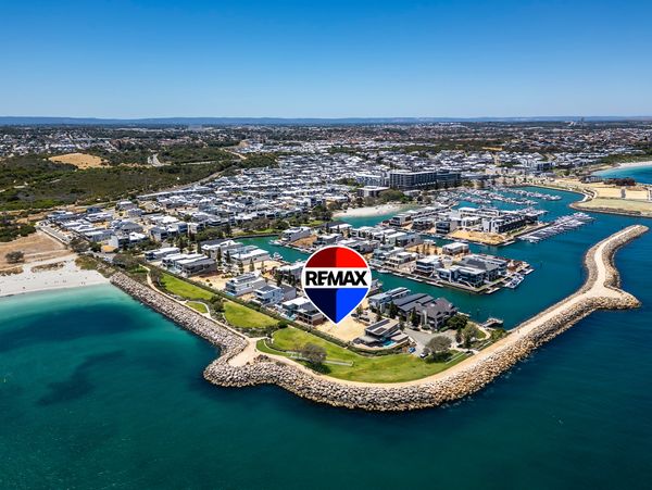 Aerial view of a coastal residential area with marina and waterfront homes.