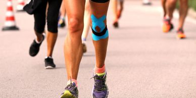 WorkoutStyles Runner's legs showing physio tape on left knee.
