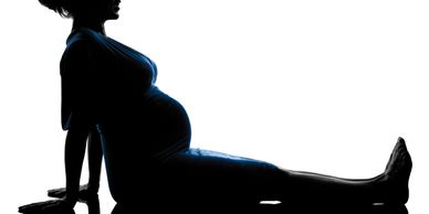 WorkoutStyles  Pregnant woman exercising sitting on a mat