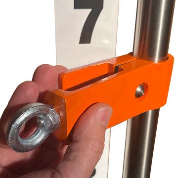 Hand adjusting an orange clamp on a metal pole.