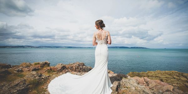 Bride posing next to sea