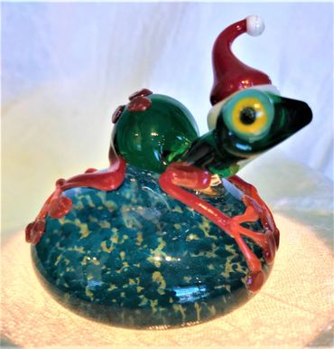 Santa's helper frog paper weight made of hand blown glass. 