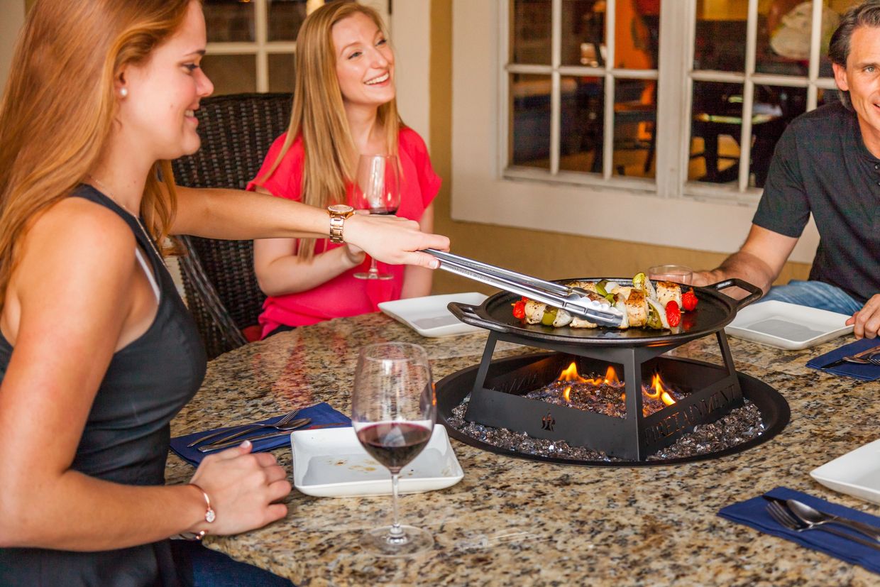 Family cooking around their Firetainment fire table