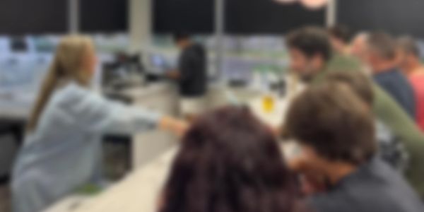 People gathered around a counter in a cozy indoor setting.