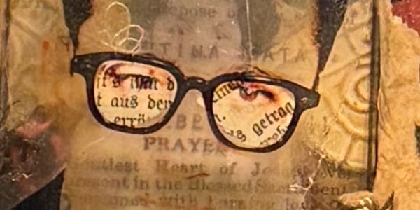 Artistic image of eyeglasses with text reflected in the lenses.