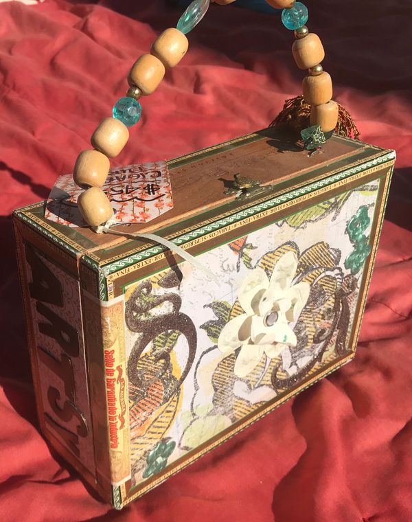 Decoupaged wooden cigar box made into a purse with a beaded handle