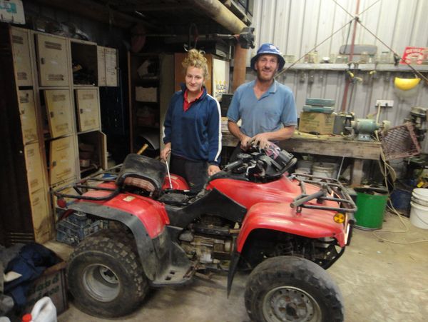 Louise and her dad working on a motor bike