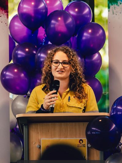 Louise speaking, balloons in the background