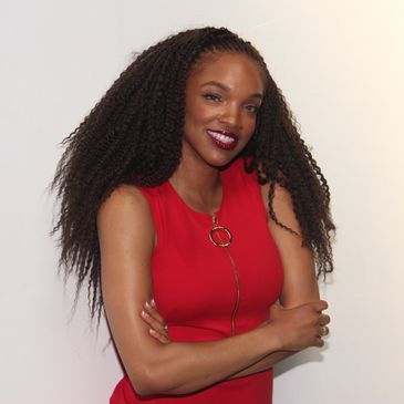 Smiling Mayalyn Hardee in red dress with curly hair.