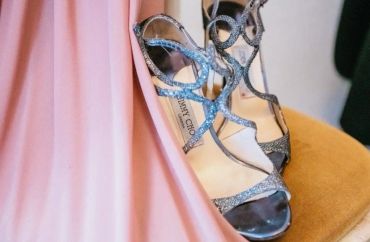 Elegant silver strappy heels paired with a flowing pink dress.