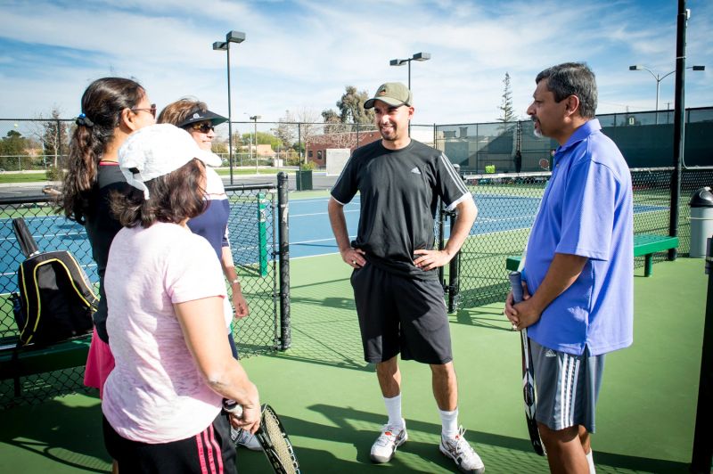 Coach talking with players on court