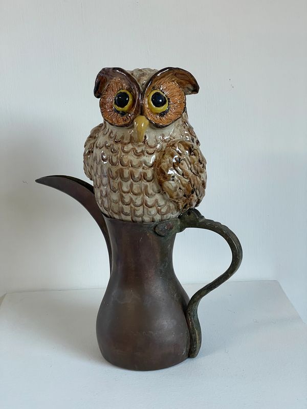 Ceramic owl in a copper dalah.