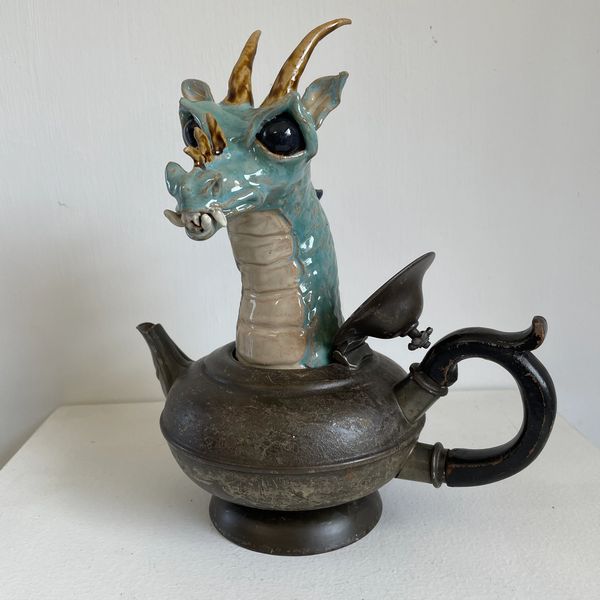 A dragon emerging from a teapot