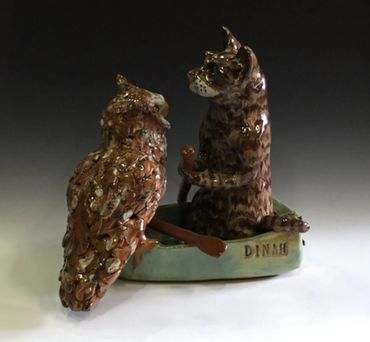 Owl and cat in boat
