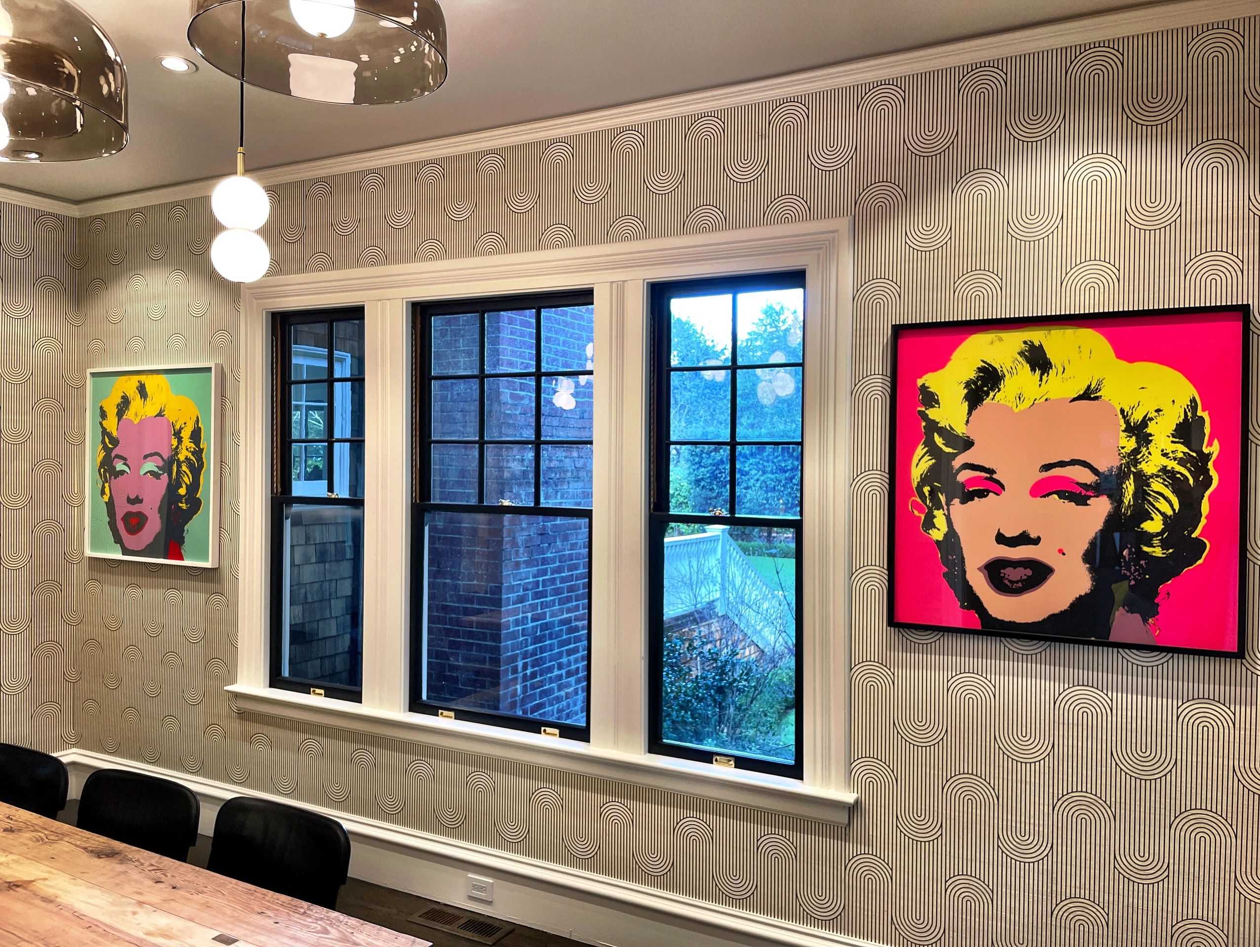 Modern dining room with retro wallpaper and Marilyn Monroe pop art.