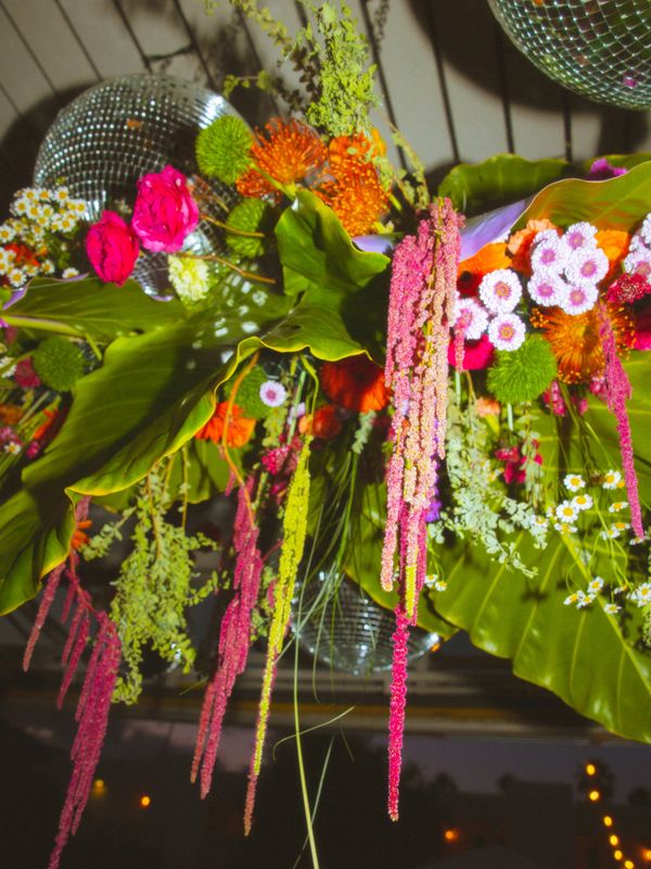 Vibrant floral arrangement with hanging greenery and disco balls.
destination weddings
wedding design
wedding planning services

