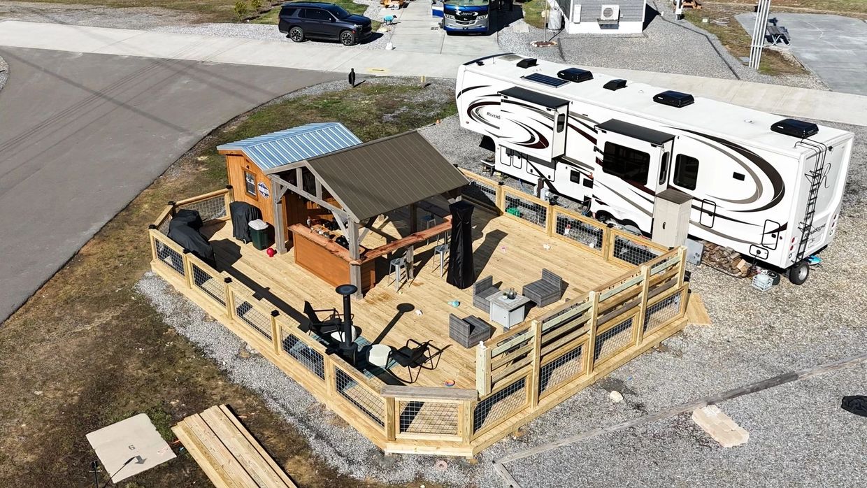 Deck with privacy wall , gazebo, outdoor bar, and shed. 