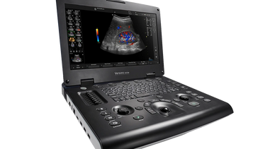 Portable ultrasound machine displaying a colored sonogram image.