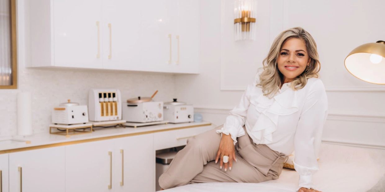 Woman relaxing in a stylish white kitchen.