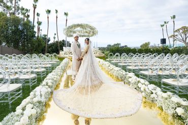 The magic of love: the bride and groom surrounded by thousands of white orchids and delicate roses.