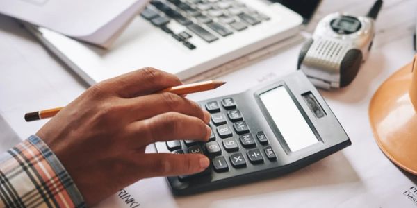 Person using a calculator at a desk.