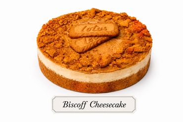 A creamy Biscoff cheesecake topped with crushed Biscoff cookies and a whole cookie.