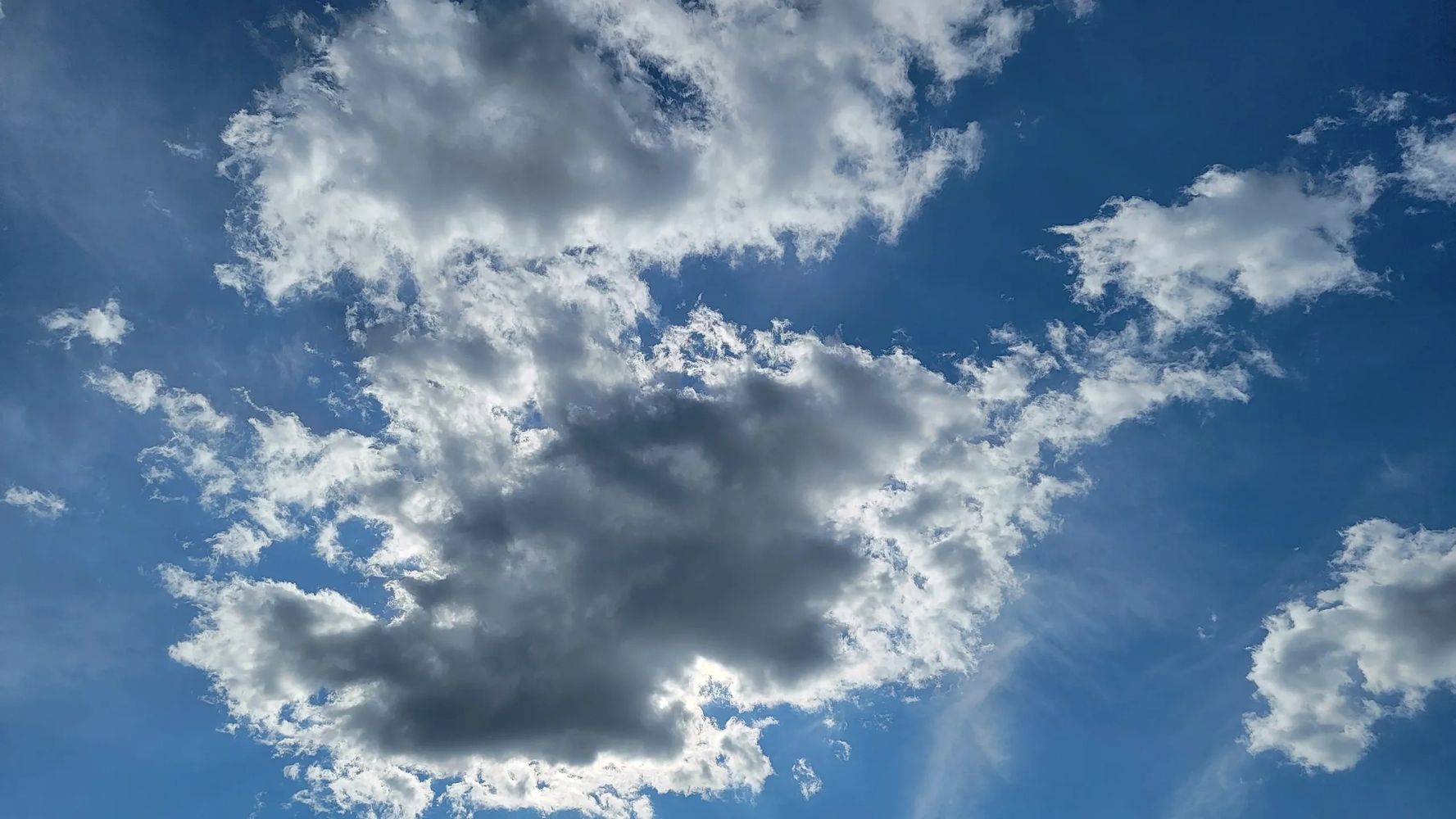 Image of beautiful fluffy clouds in front of a bright blue sky