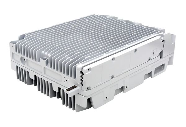 White electronic device with cooling fins and connectors.