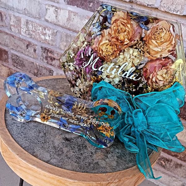 Memorial display with dried flowers and a tribute plaque for Matilda.