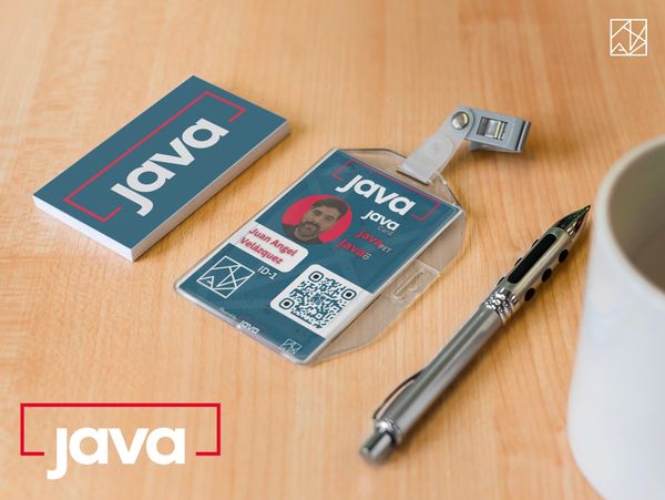 Java-themed ID card and badge holder on a wooden desk with a pen and coffee cup.