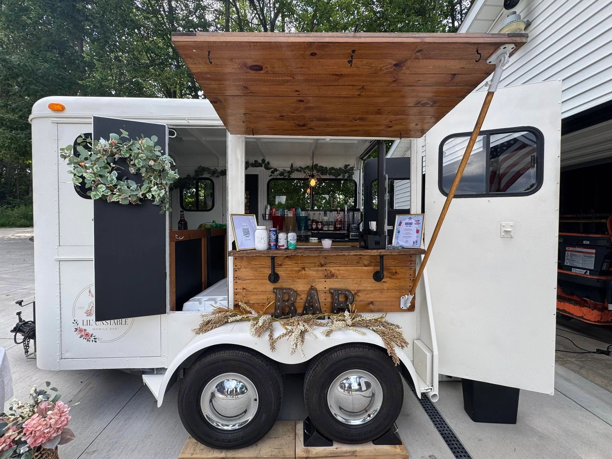 White aesthetic mobile bar trailer set-up for bar service.