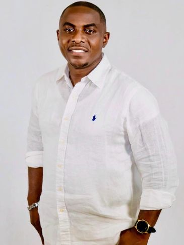 Man in white shirt smiling at the camera.