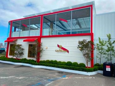 Modern building with red frame and GH Mumm logo.