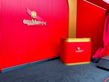 Red and gold G.H. Mumm branded booth setup.