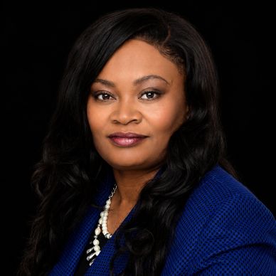 Professional portrait of a confident woman in a blue blazer.