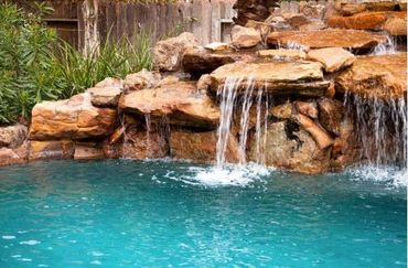 Waterfall flowing into a clear pool.