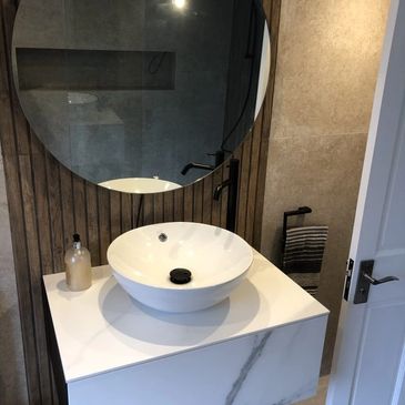 New renovated bathroom with wood effect splash back tiles. 