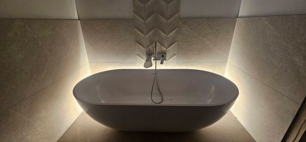 Beautiful Lusso Stone bath fitted in Horsell with LED accent lighting to create a Spa feel
