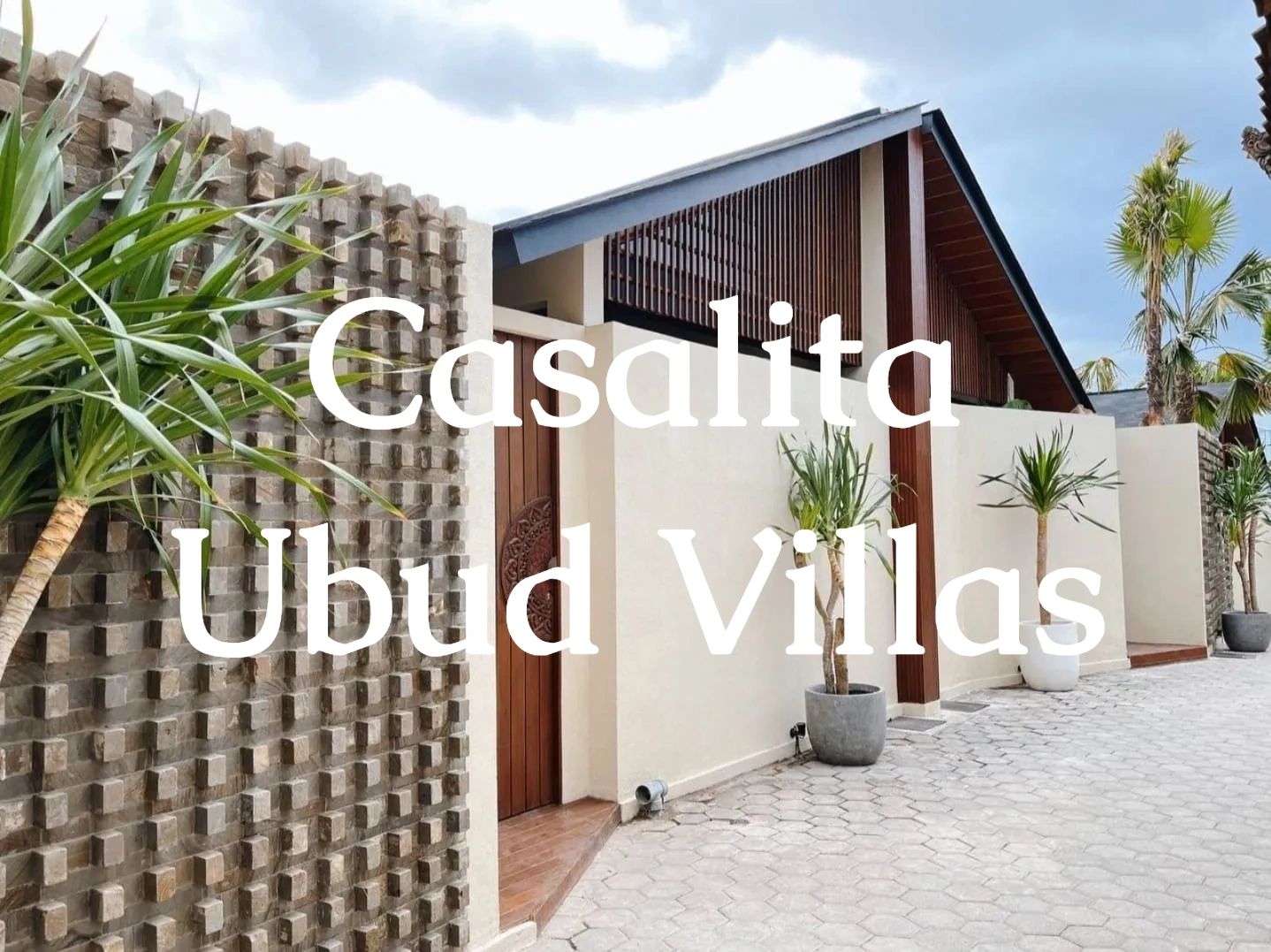 Modern villa entrance at Casalita Ubud Villas with tropical plants.