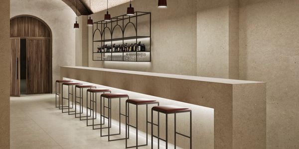 Minimalist bar interior with stools and ambient lighting.