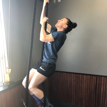 Jocelyne Larocque, a stoke coach, climbing a rope