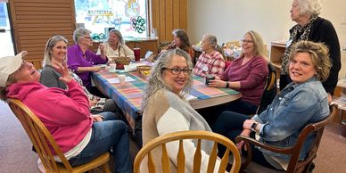 People gathered around a table enjoying coffee.